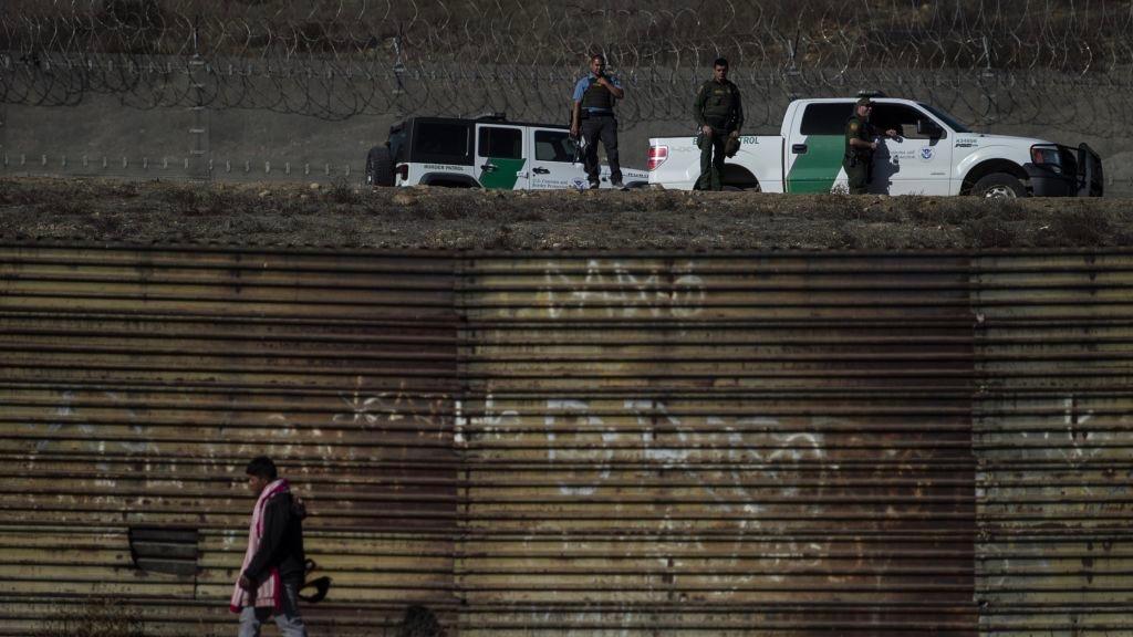 US Border Patrol officers stand guard along the shallow concrete waterway of the Tijuana River as Central American migrants -mostly from Honduras- are trying to reach US soil from Tijuana, Baja California State, Mexico, on November 25, 2018. (Pedro Pardo/AFP/Getty Images)
