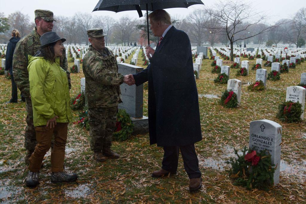 President Donald Trump shakes the hand of a U.S. military member during an unscheduled visit to Arlington National Cemetery in Arlington, Virginia on Dec. 15, 2018. (ROBERTO SCHMDIT/AFP/Getty Images)