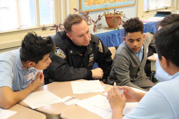 A NYPD police officer works with a group of mentees. (Courtesy of BBBS of NYC)