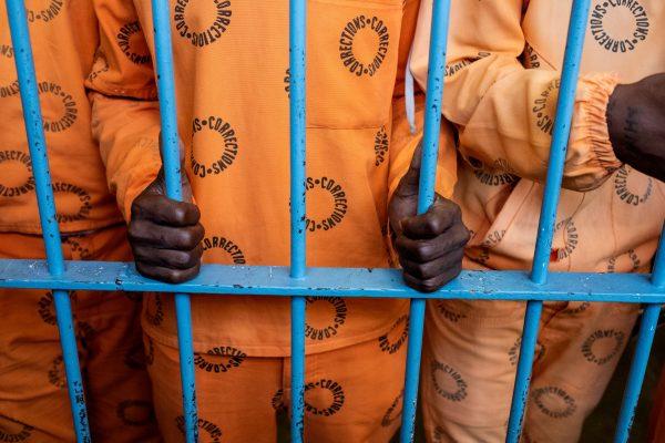 Inmates stand behind bars in a jail at Bryansto, South Africa on Oct. 30, 2018, (Wikus de Wet/AFP/Getty Images)
