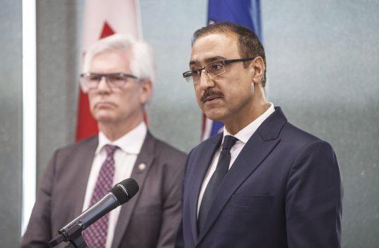 Minister of Natural Resources Amarjeet Sohi (R) and Minister of International Trade Diversification Jim Carr speak during a press conference to announce support for Canada's oil and gas sector, in Edmonton on Dec. 18, 2018. (The Canadian Press/Jason Franson)