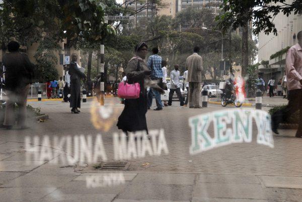 Kenyans walk past a store front promoting t-shirts for sale that read "Hakuna Matata" and "Kenya" in Nairobi on Feb. 12, 2008. (Walter Astrada/AFP/Getty Images)