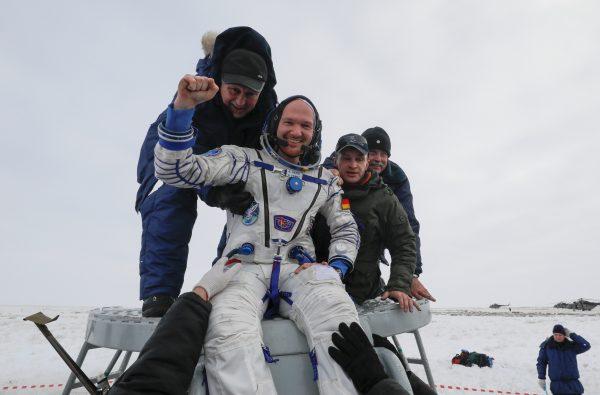 Ground personnel help International Space Station crew member Alexander Gerst of Germany to get out of the Soyuz MS-09 capsule after landing in a remote area near the town of Zhezkazgan, Kazakhstan, on Dec. 20, 2018. (Reuters/Shamil Zhumatov)
