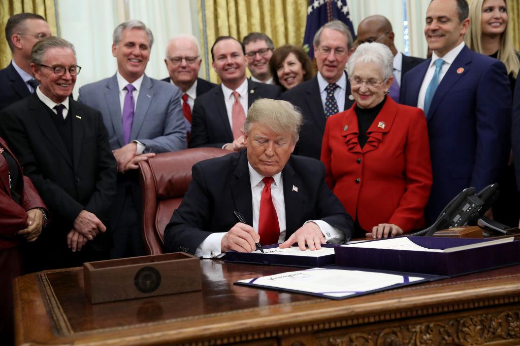 President Donald Trump signs the First Step Act and the Juvenile Justice Reform Act in the Oval Office of the White House Dec. 21, 2018 in Washington. (Win McNamee/Getty Images)