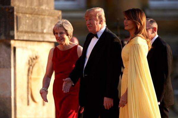 US First Lady Melania Trump (2R) and US President Donald Trump (2L) are welcomed by Britain's Prime Minister Theresa May (L) and her husband Philip May (R) as they arrive for a black-tie dinner with business leaders at Blenheim Palace, west of London, July 12, 2018. (Niklas Halle'n/AFP/Getty Images)