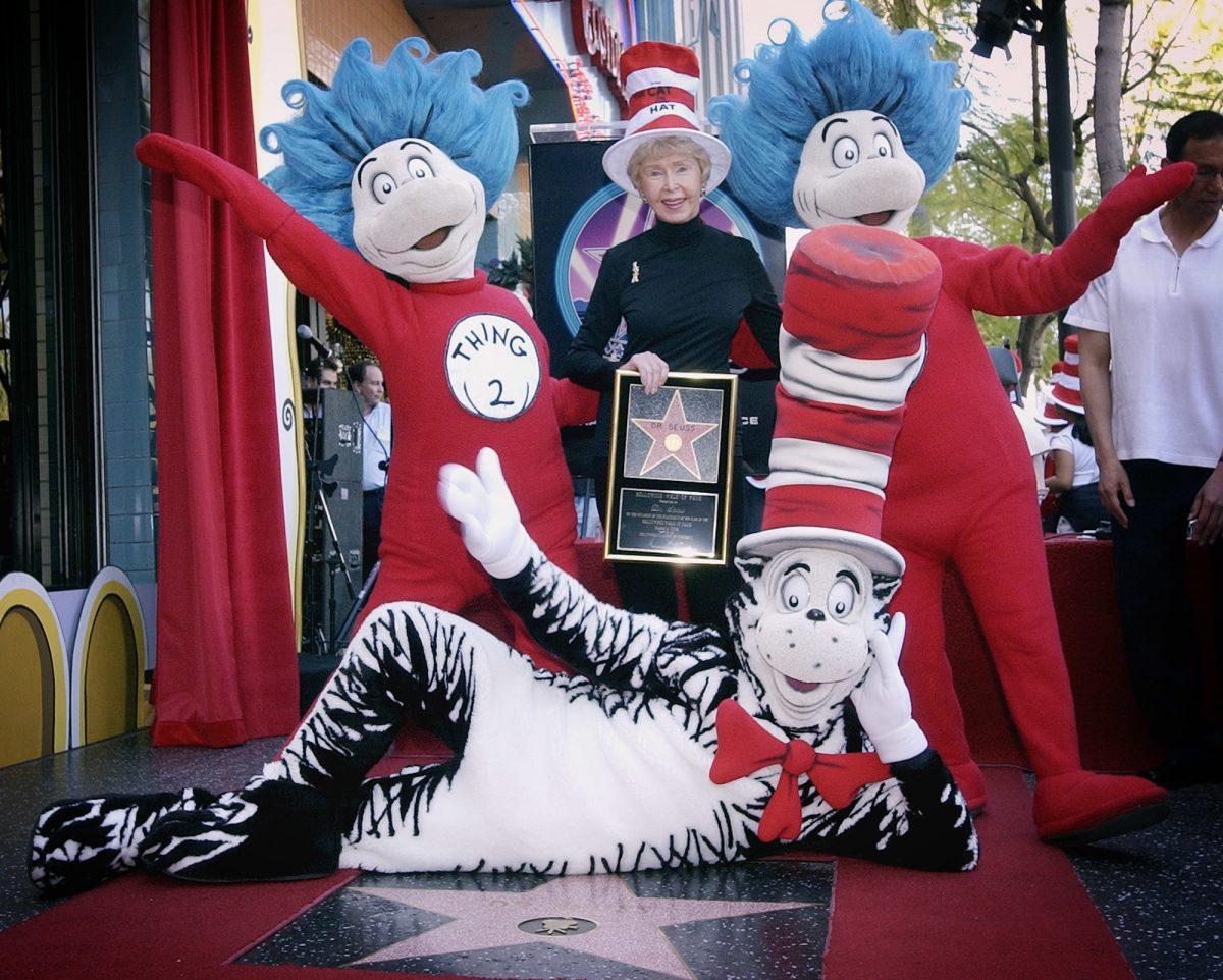 Audrey Geisel, widow of famed children's book author Theodor Seuss Geisel, better known as Dr. Seuss, poses with The Cat in the Hat, foreground, and Thing 1 and Thing 2, who are characters from his books, at the dedication of Dr. Seuss' posthumous star on the Hollywood Walk of Fame in Los Angeles, on March 11, 2004. (Reed Saxon/AP File Photo)
