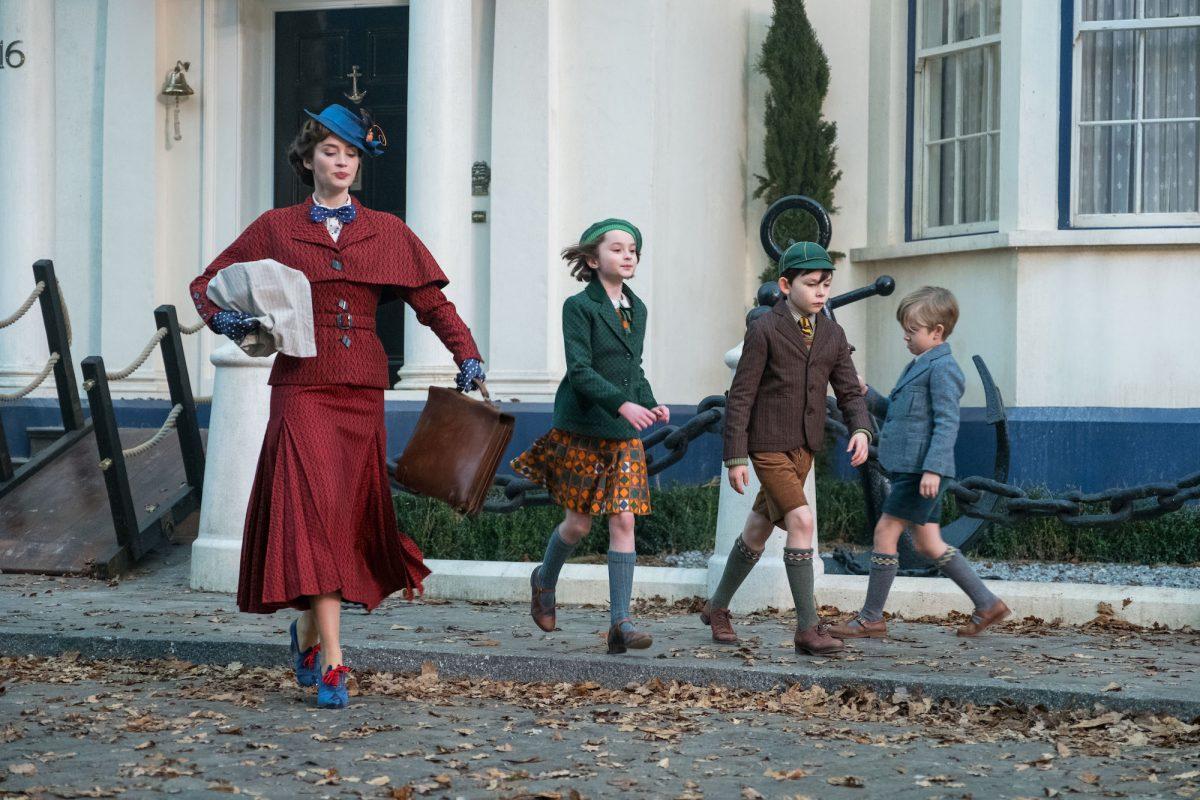 (L–R) Mary Poppins (Emily Blunt) and her new charges Annabel Banks (Pixie Davies), John Banks (Nathanael Saleh), and Georgie Banks (Joel Dawson) start out on an outing. (Disney)