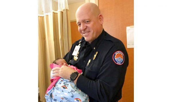 Paramedic Mickey Huber holds 2-day-old baby Zoele Mickey Skinner at Enloe Medical Center in Chico, Calif on Dec. 14, 2018. (Daniel Skinner via AP)