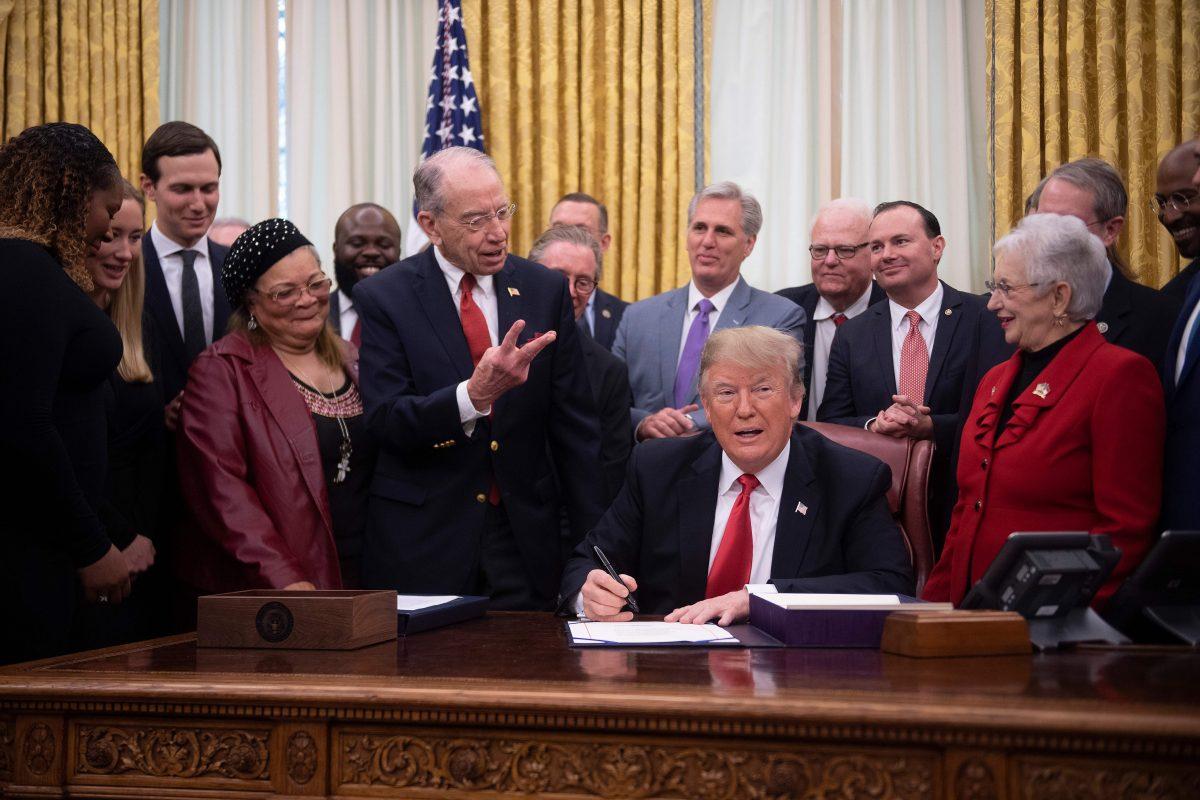 President Donald Trump (C) talks with US Senator Chuck Grassley (C L), R-Iowa, as he signs the "First Step Act" and the "Juvenile Justice Reform Act" at the White House in Washington on Dec. 21, 2018. (Jim Watson/AFP/Getty Images)