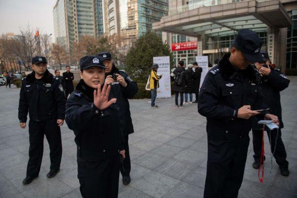 Police often enforce censorship on the people of China. officers stop people from taking photos in Beijing on December 20, 2018. (Photo by Nicolas ASFOURI / AFP) (Photo credit should read NICOLAS ASFOURI/AFP/Getty Images)