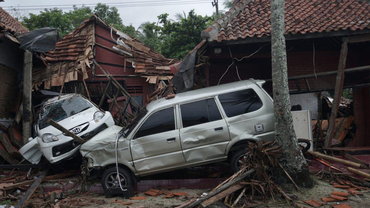 Damaged cars among collapsed houses after a tsunami hit Banten, Indonesia, Dec. 22, 2018. (Antara Foto/Muhammad Bagus Khoirunas/ via Reuters)
