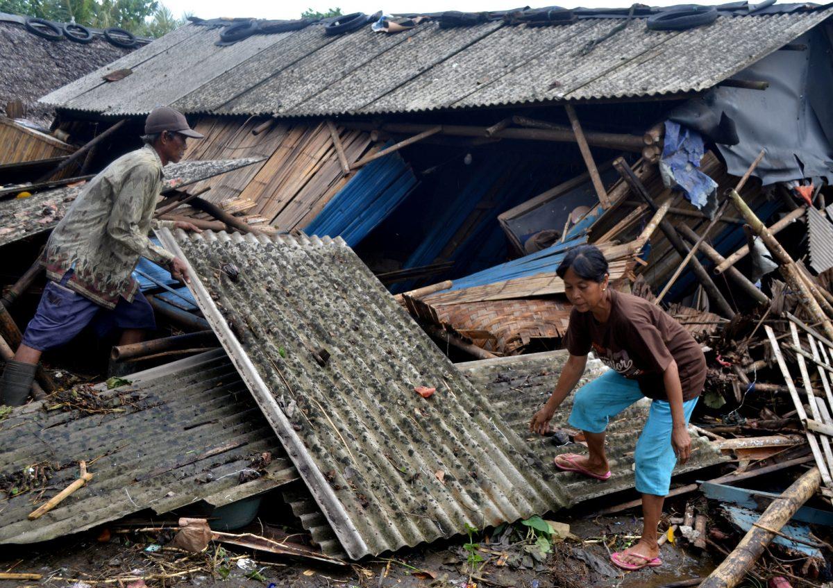 Residents collect debris from their collapsed house after it was hit by a tsunami at Panimbang district in Pandeglang, Banten province, Indonesia, Dec. 23, 2018.<br/>(Antara Foto/Muhammad Bagus Khoirunas/ via Reuters)