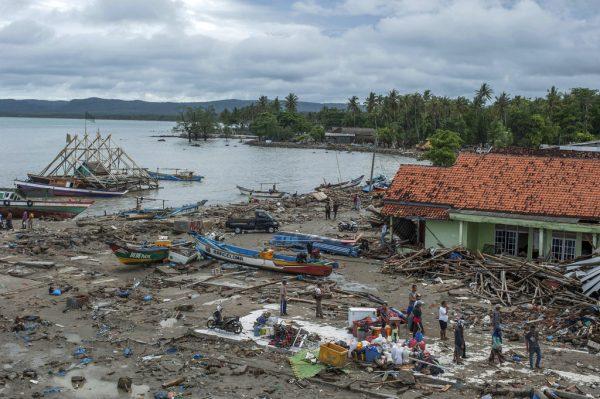 People inspect the damage at a tsunami-ravaged village in Sumur, Indonesia on Dec. 24, 2018. (Fauzy Chaniago/AP)