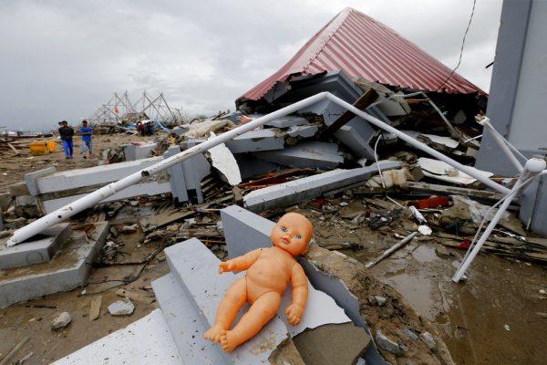 A doll lays outside a damaged house following the tsunami in Sumur, Indonesia on Dec. 25, 2018. (AP Photo/Tatan Syuflana)