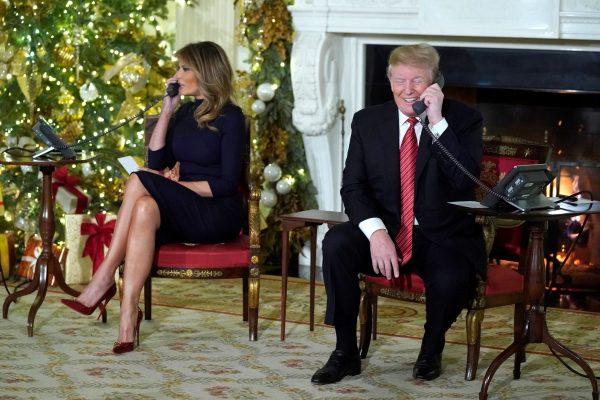 President Donald Trump and first lady Melania Trump participate in NORAD Santa tracker phone calls from the White House in Washington on Dec. 24, 2018. (Jonathan Ernst/Reuters)