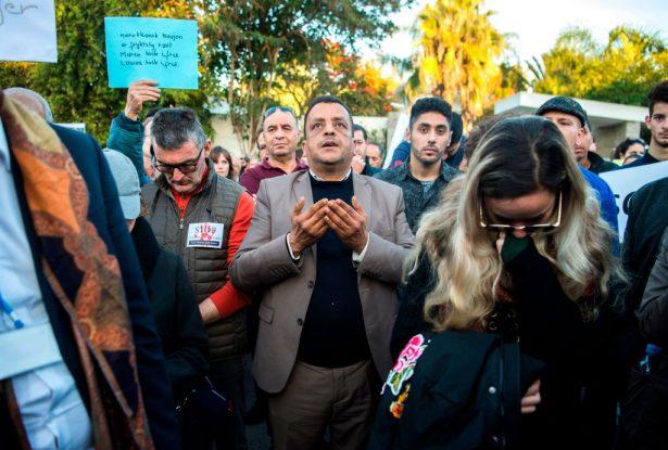 A man prays as Moroccans pay tribute to murdered Danish Louisa Vesterager Jespersen and Norwegian Maren Ueland in Rabat on Dec. 22. (FADEL SENNA/AFP/Getty Images)