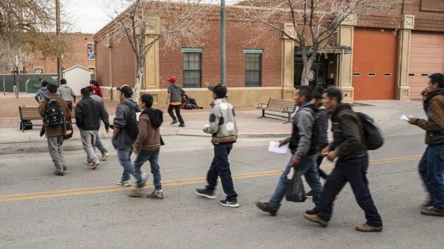 Central American migrants are pictured making their way to El Paso Sun Metro busses after being dropped off in downtown El Paso by Immigration and Customs Enforcement late in the afternoon on Christmas day on Dec. 25, 2018. (Paul Ratje/AFP/Getty Images)