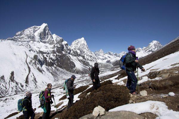 Trekkers take an acclimatization hike to Nagarzhang peak above Dingboche valley on the way to Everest base camp in Nepal, on March 18, 2015. (AP Photo/Tashi Sherpa)