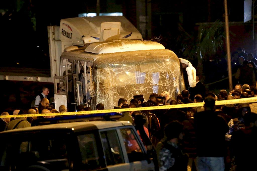 Security forces stand near a tourist bus after a roadside bomb in an area near the Giza Pyramids in Cairo, Egypt, on Dec. 28, 2018. (AP/Nariman El-Mofty)
