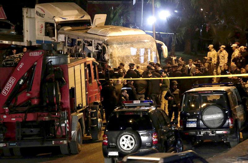 Security forces stand near a tourist bus after a roadside bomb in an area near the Giza Pyramids in Cairo, Egypt. (AP Photo/Nariman El-Mofty)