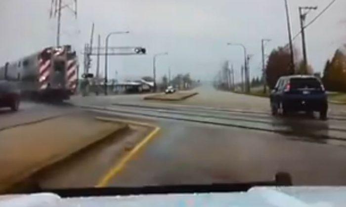 Dashcam Footage Shows Police Officer Swerving to Avoid Oncoming Train