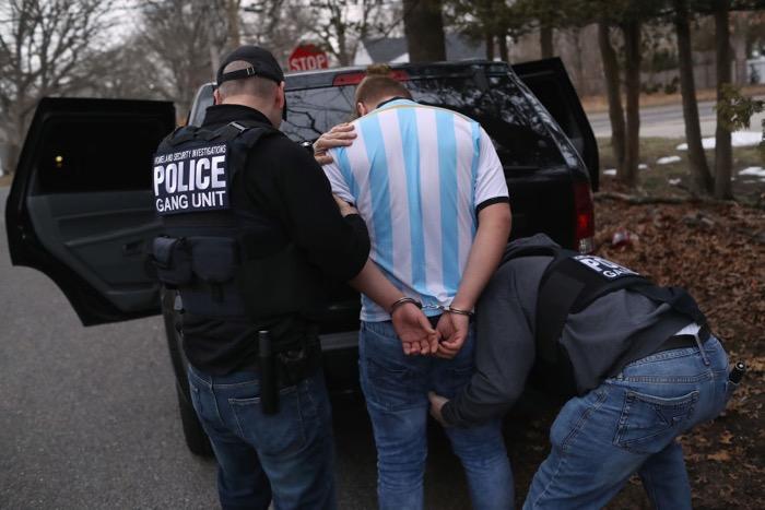 In this March 29, 2018, file photo, Immigration and Customs Enforcement (ICE) agents frisk a suspected MS-13 gang member and Honduran immigrant after arresting him at his home in Brentwood, New York. (John Moore/Getty Images)