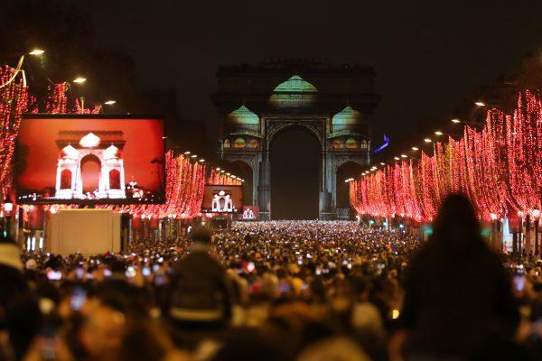 Revelers gather near the illuminated Arc de Triomphe on the Champs-Elysees for New Year's celebrations in the French capital Paris on Dec. 31, 2018. (Zakaria Abdelkafi/AFP/Getty Images)