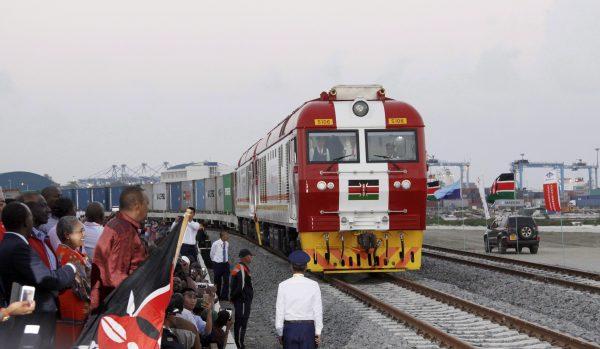Kenyan President Uhuru Kenyatta (3rd L) watches during the opening of the SGR cargo train runs on a China-backed railway from the port containers depot in Mombasa, Kenya, to Nairobi on May 30, 2017. (AP Photo/Khalil Senosi)