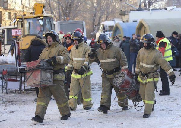Emergency Situations employees working at the scene of a collapsed section of an apartment building, in Magnitogorsk, Russia, on Dec. 31, 2018. (Russian Ministry for Emergency Situations photo via AP)
