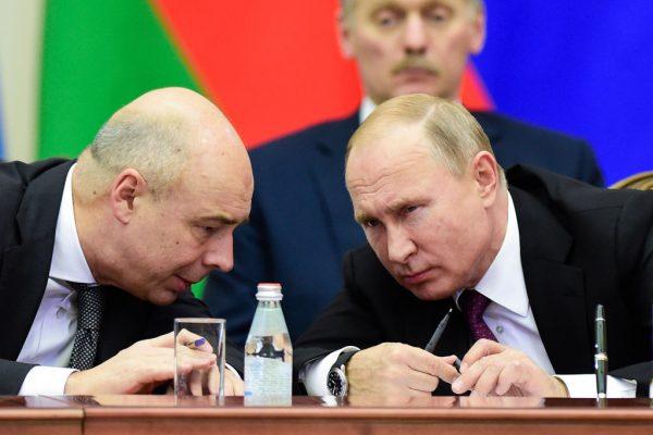 Russian President Vladimir Putin (R) and Finance Minister Anton Siluanov chat during a meeting of the Supreme Eurasian Economic Council in Saint Petersburg, Russia, on Dec. 6, 2018. (Olga Maltseva/AFP/Getty Images)