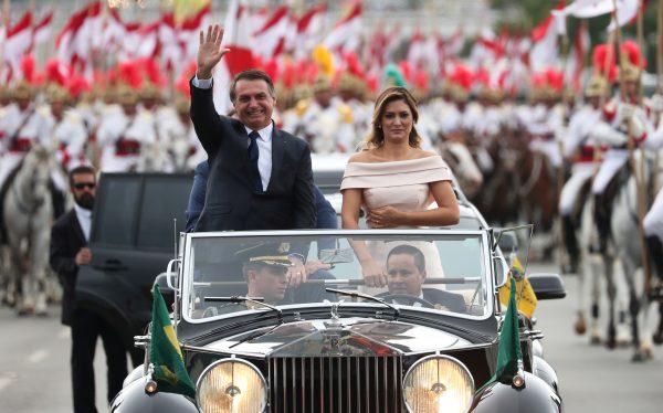 Brazil's new President Jair Bolsonaro waives as he drives past before his swear-in ceremony, in Brasilia, Brazil, on Jan. 1, 2019. (Reuters/Ricardo Moraes)