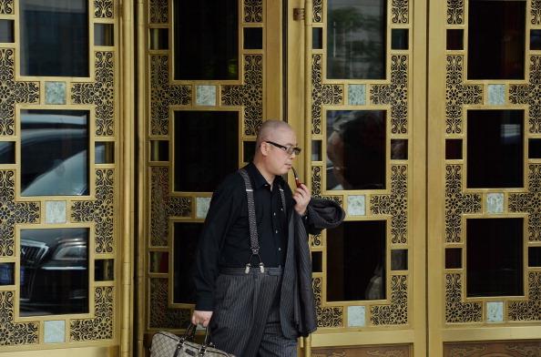 A Chinese businessman leaving an upmarket restaurant in the historic Qianmen district of Beijing on May 7, 2013. (Mark Ralston/AFP/Getty Images)