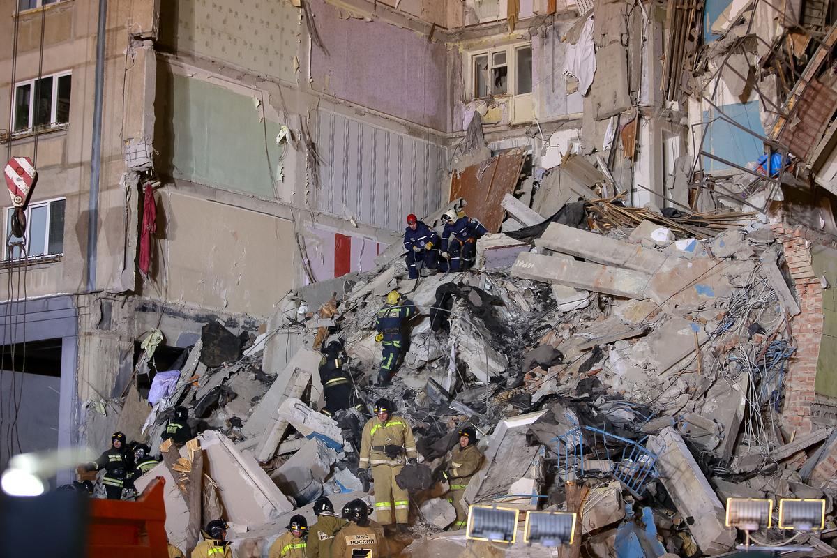 Emergency officers inspect rubble as they take part in a rescue operation after a gas explosion rocked a residential building in Russia's Urals city of Magnitogorsk on Dec. 31, 2018. (STR/AFP/Getty Images)