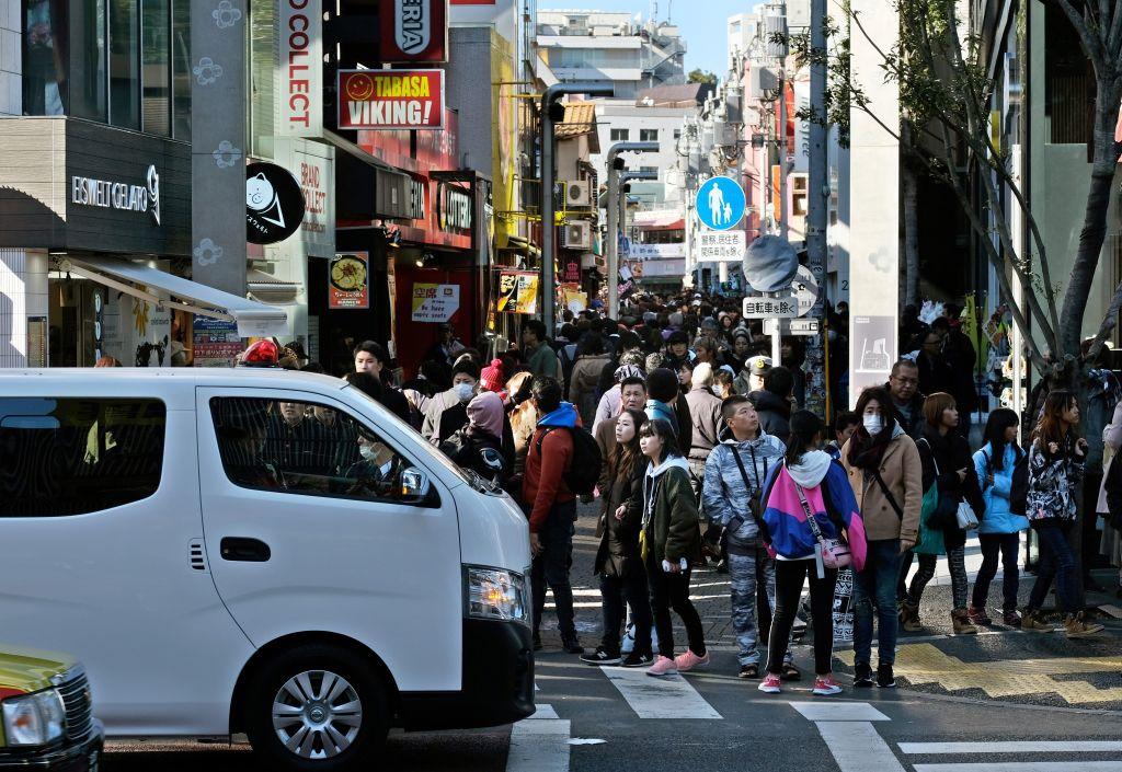 A police vehicle (L) sits parked at an entrance leading to Takeshita Street the morning after a man drove into the crowd on New Year's Eve in Tokyo's fashion district of Harajuku on Jan. 1, 2019.(Kazuhiro Nogi/AFP/Getty Images)