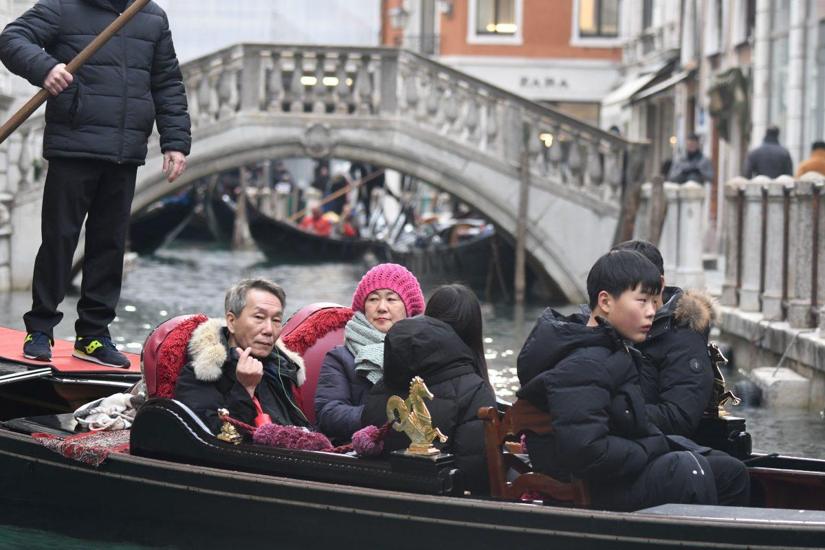  A group of tourists sits on a gondola sailing on a canal of Venice on Jan. 19, 2018. (Andrea Pattaro/AFP/Getty Images)