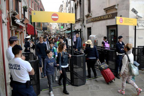 Venice's citizens and tourists pass through turnstiles limiting the massive flows of tourists in the city's main streets on May 1, 2018. (Andrea Pattaro/AFP/Getty Images)