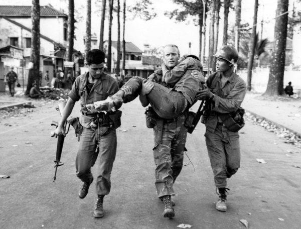 An American soldier carries a wounded South Vietnamese Ranger to an ambulance after a battle with the Viet Cong during the Tet Offensive in Saigon, Vietnam, on Feb. 6, 1968. (AP Photo/Dang Van Phuoc)