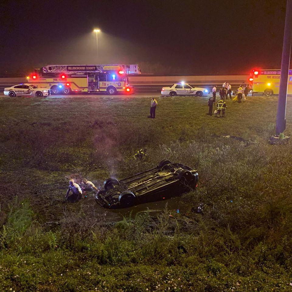 Deputies wade out to an overturned car near the I-4 highway in Florida, on Jan. 1, 2019. (Hillsborough County Sheriff)