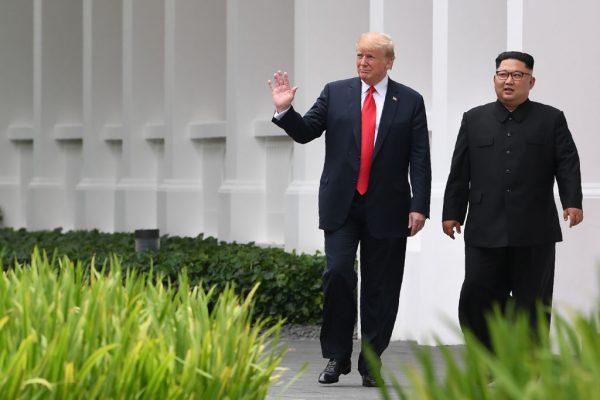North Korea's leader Kim Jong Un (R) walks with President Donald Trump during a break in talks at their historic U.S.-North Korea summit on Sentosa Island in Singapore on June 12, 2018. (SAUL LOEB/AFP/Getty Images)