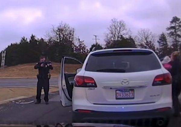 The moment a police officer pulls a 1-year-old from a car during an armed standoff with Farris Deloney, 43, in Little Rock, Ark. (Screenshot/Little Rock Police)