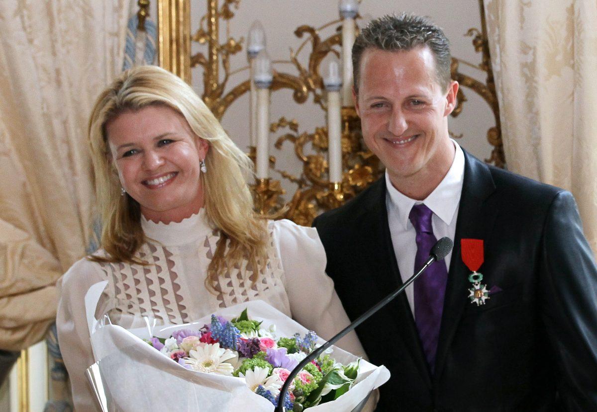 Michael Schumacher with wife Corinna after he was awarded the French Legion of Honor in Paris on April 29, 2010. (Thomas Coex/AFP/GettyImages)