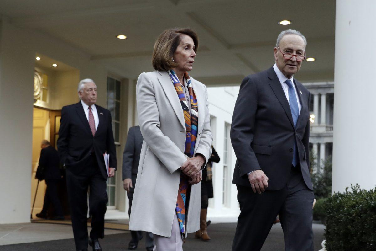 House Democratic leader Rep. Nancy Pelosi of California, and Senate Minority Leader Chuck Schumer, D-N.Y., walk to speak with reporters after a meeting with President Donald Trump on border security at the White House in Washington on Jan. 2, 2019. (AP Photo/Evan Vucci)