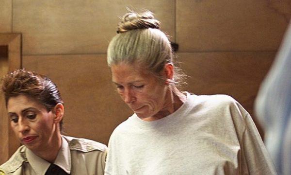 Corrections officer Sandra Fuentes assists Leslie Van Houten as she arrives for her parole hearing before members of the Board of Prison Terms at the California Institution for Women in Corona, Calif., on June 28, 2002. (Damian Dovarganes/AFP/Getty Images)