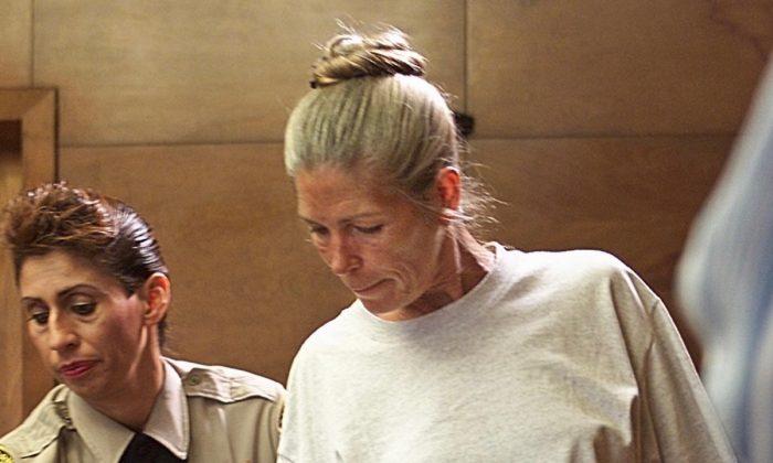 Corrections officer Sandra Fuentes assists Leslie Van Houten as she arrives for her parole hearing before members of the Board of Prison Terms at the California Institution for Women in Corona, Calif., on June 28, 2002. (Damian Dovarganes/AFP/Getty Images)