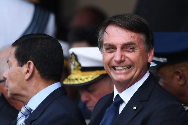 Brazilian President Jair Bolsonaro smiles during the ceremony in which Lieutenant-Brigadier Antonio Carlos Moretti takes the helm of the Brazilian Air Force, at Brasilia's Air Base on January 4, 2019. (Evaristo Sa/AFP/Getty Images)