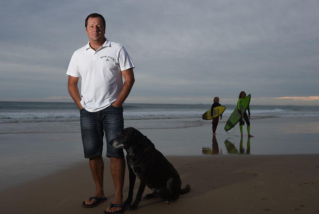 This photo taken on May 1, 2016 shows Australian shark attack victim Dave Pearson standing on Crowdy Head beach south of Ballina with his dog Mojo where he was attacked by a three metre Bull Shark in 2011. (Peter Parks/AFP/Getty Images)