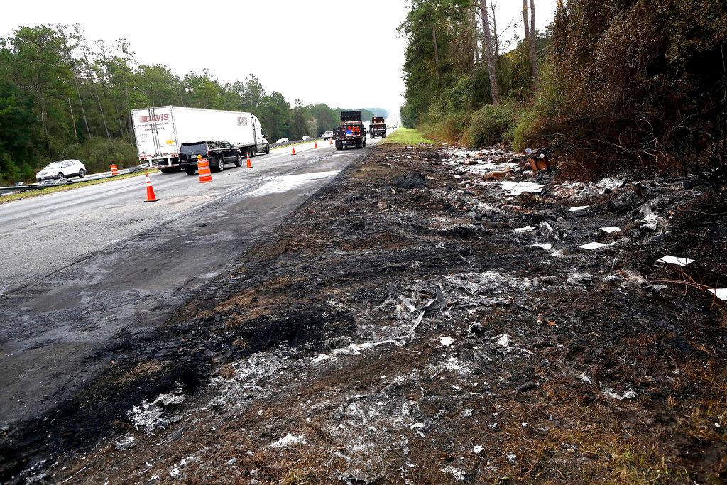 Debris off the south bound side of Interstate 75 remains at the scene of Thursday's multi-vehicle accident that caused multiple fatalities between Alachua and Gainesville, Fla., on Friday, Jan. 4, 2019. (Brad McClenny/The Gainesville Sun via AP)