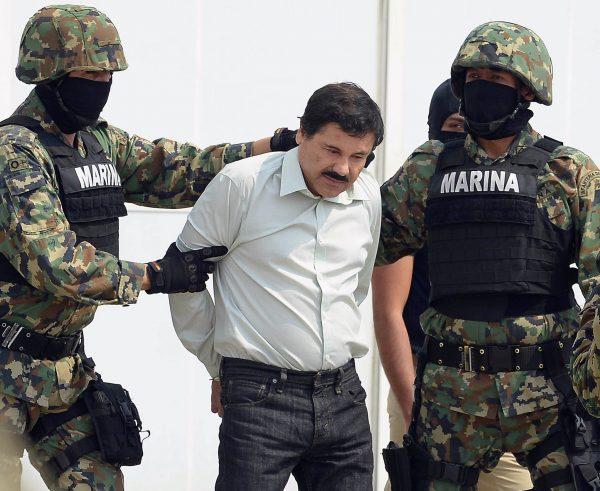 Mexican drug trafficker Joaquin Guzman Loera (el Chapo Guzman), is escorted by marines as he is presented to the press in Mexico City, on Feb. 22, 2014. (Alfredo Estrella/AFP/Getty Images)