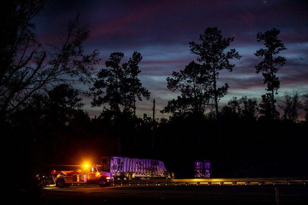 Workers labor into the night to clear the wreckage of the fiery multi-car crash which killed seven people. (Lauren Bacho/The Gainesville Sun via AP)