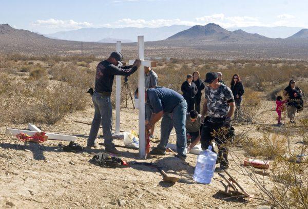 People place crosses near the graves where the McStay family was found in Victorville, Calif. (John Gibbins/The San Diego Union-Tribune/AP)